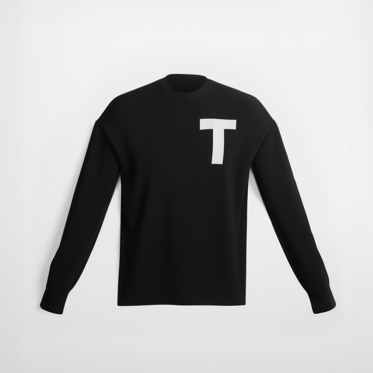 Black long-sleeve shirt with a white letter 'T' on a light gray background