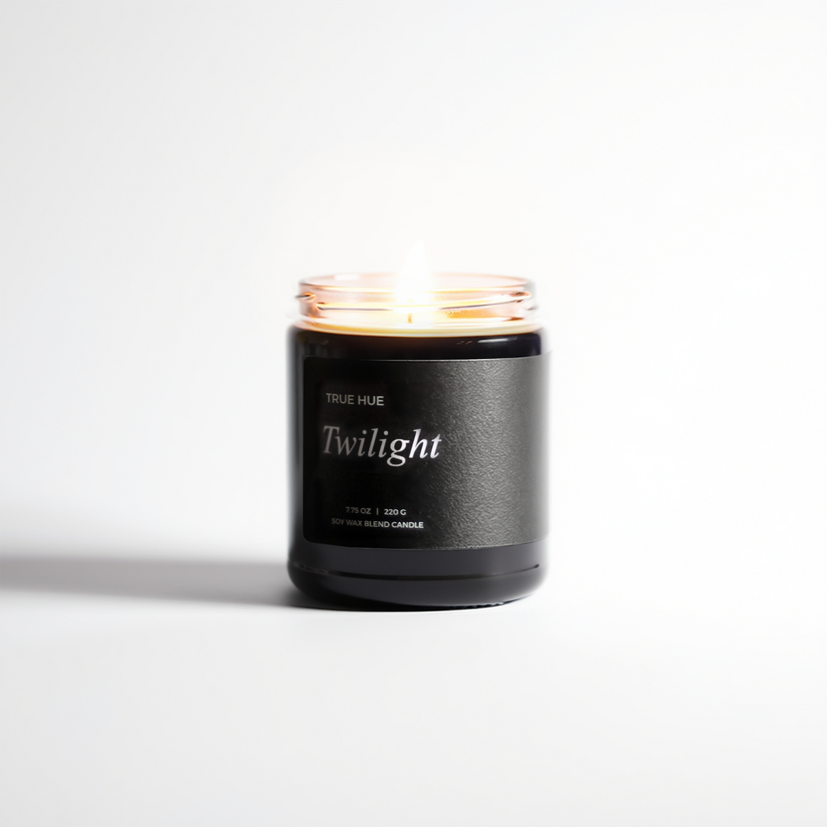 Twilight Jar Candle lit on a light gray background.