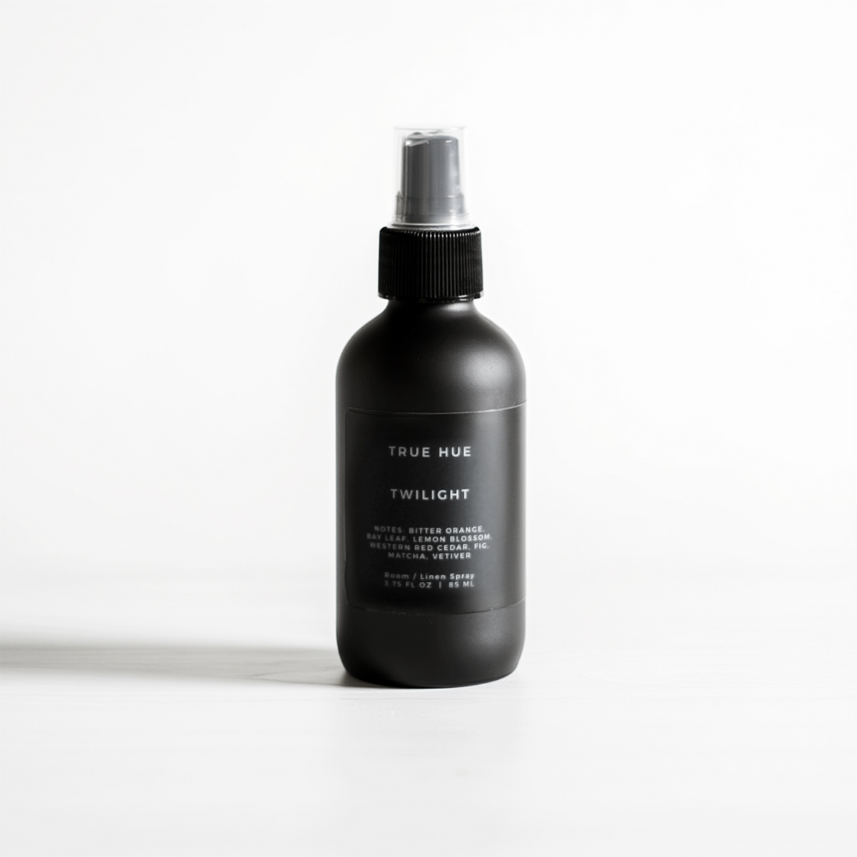 Black spray bottle labeled 'True Hue' on a white background
