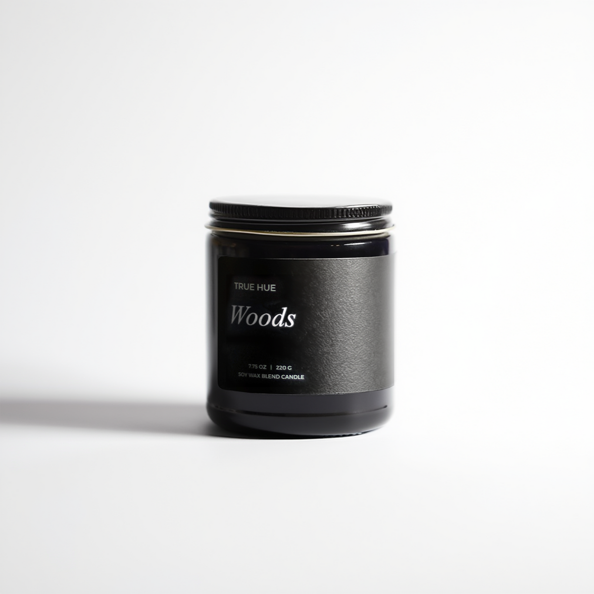 Woods Jar Candle with lid on a light gray background.