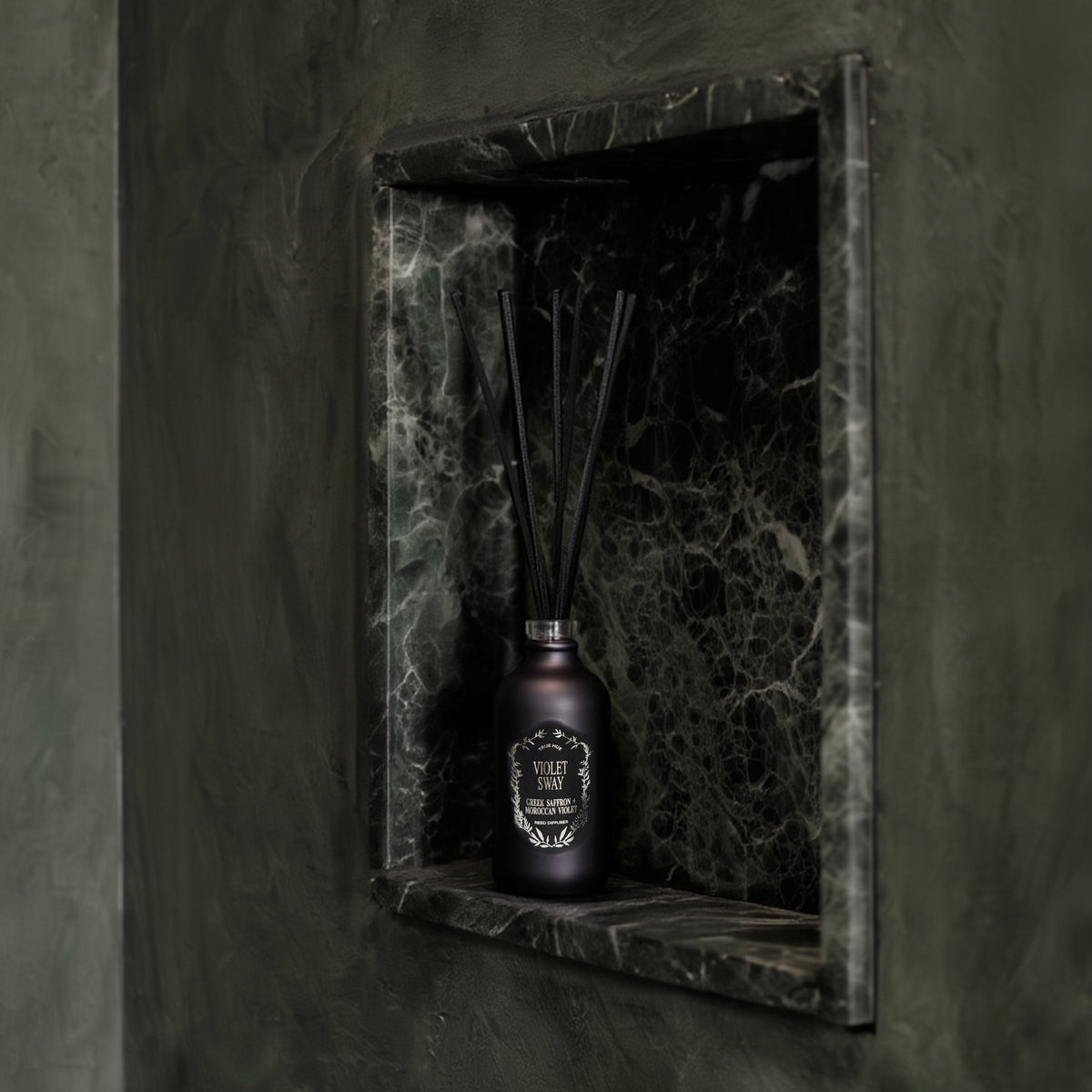 Violet Sway Reed Diffuser sitting on a green marble alcove.